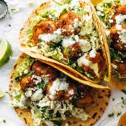 Spicy shrimp tacos with sauce.